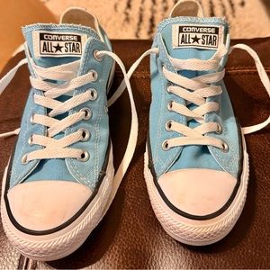 Light blue low top converse sneakers.